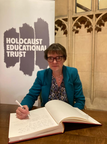 Selaine signing Holocaust Book of Commitment